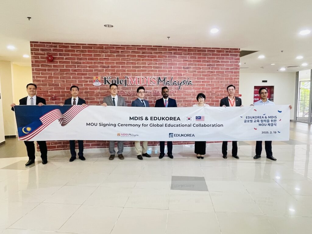 MOU signing ceremony between MDIS and EduKorea with delegates holding a banner
